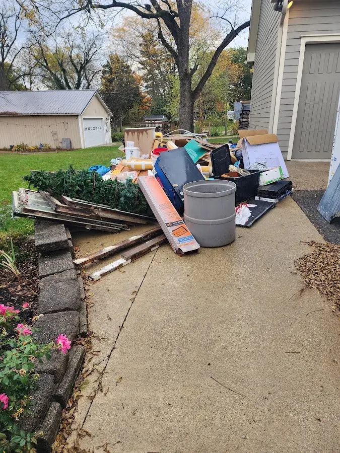 Dumpster being loaded with debris for Estate Cleanout Dumpster Rental in Ladonia